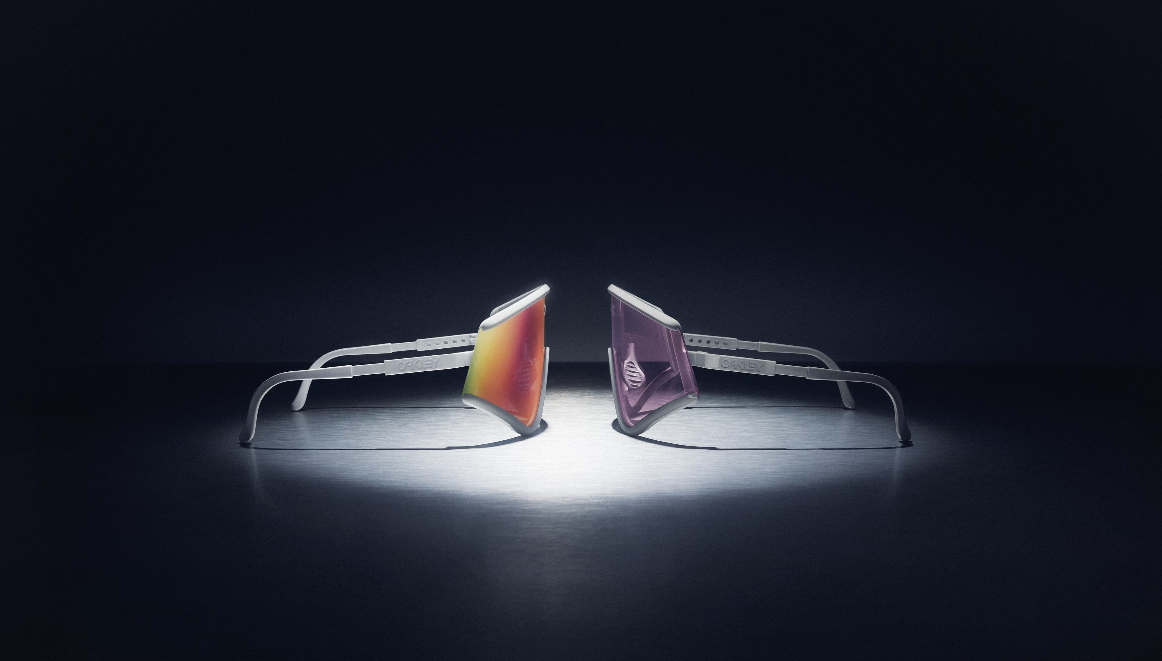 Oakley MUZM Eyeshade, both limited-edition colorways side by side: White / Prizm Road and Cool Grey / Prizm Low-Light